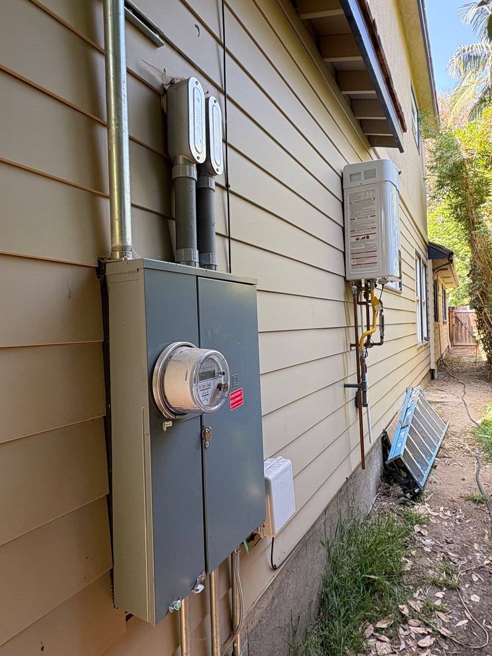 Gas and electrical meters installed on the side of a residential home.